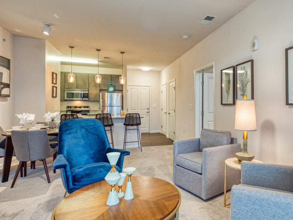 a living room and kitchen with a table and chairs