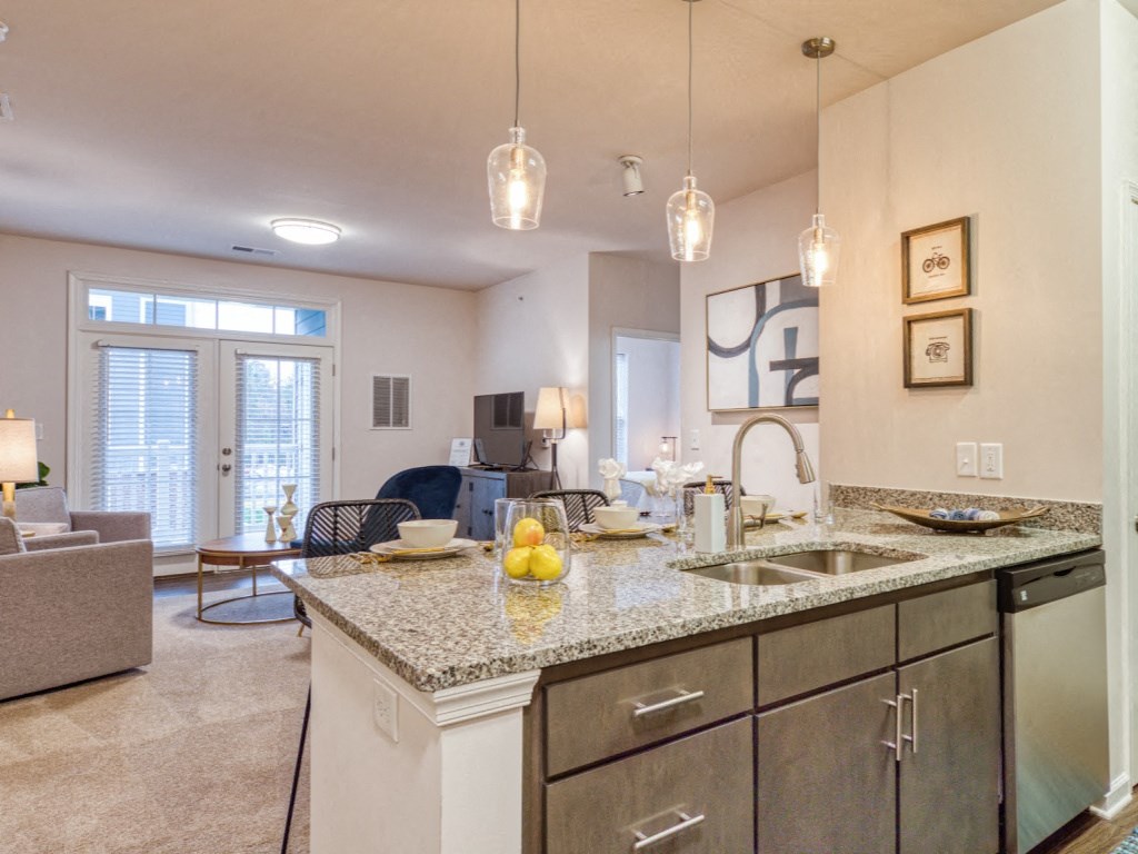 a kitchen with a sink and a counter top in a living room
