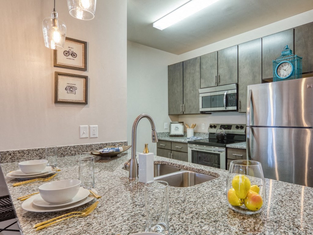 a kitchen with stainless steel appliances and granite counter tops