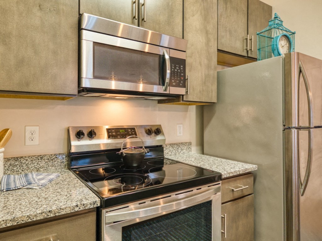 a kitchen with stainless steel appliances and granite counter tops