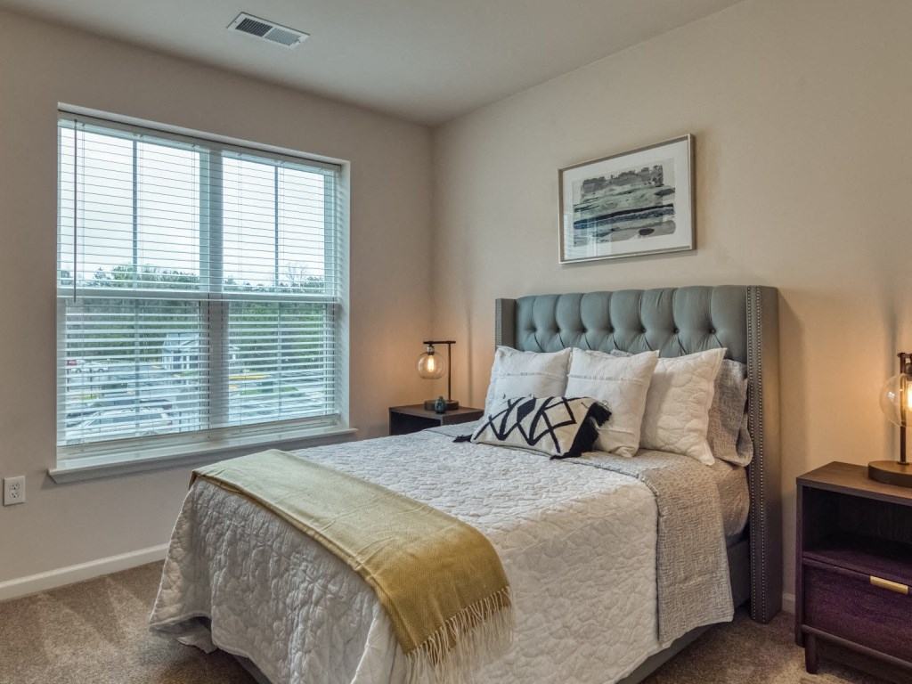 a bedroom with a large bed and a window