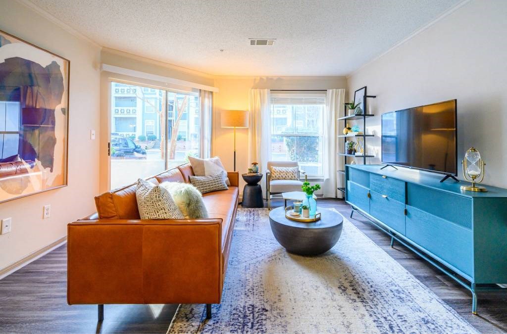 A living room with a brown couch and a blue cabinet.