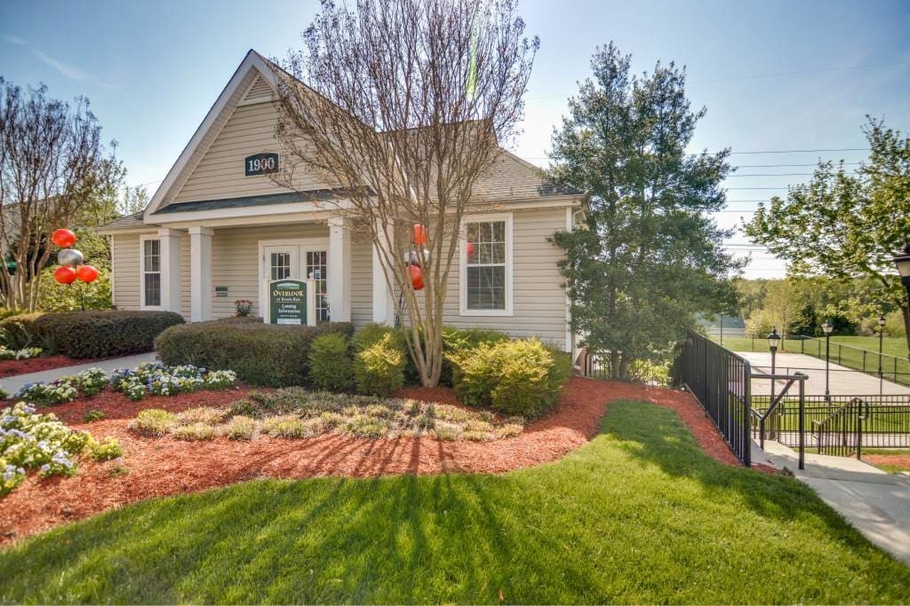 A house with a green sign on the front door.