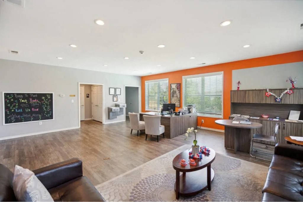 A modern living room with a brown leather couch and a coffee table.