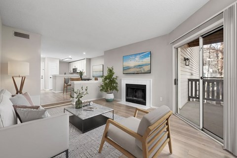 A modern living room with a fireplace and a painting on the wall.
