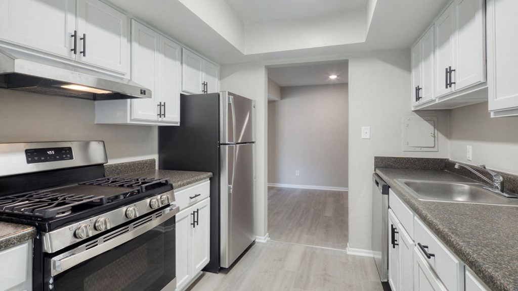 a kitchen with white cabinets and stainless steel appliances  at Bayville Apartments, Virginia Beach, Virginia