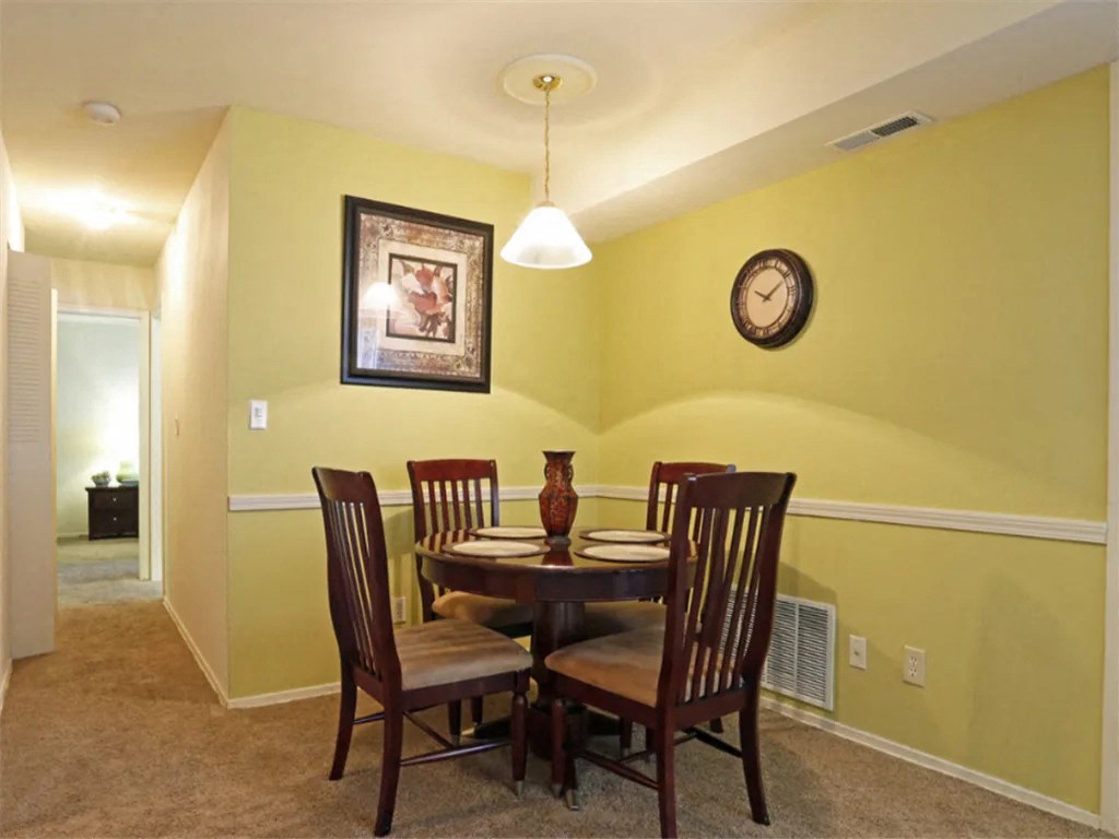 a dining room with a table and chairs at Gates of West Bay, Norfolk Virginia