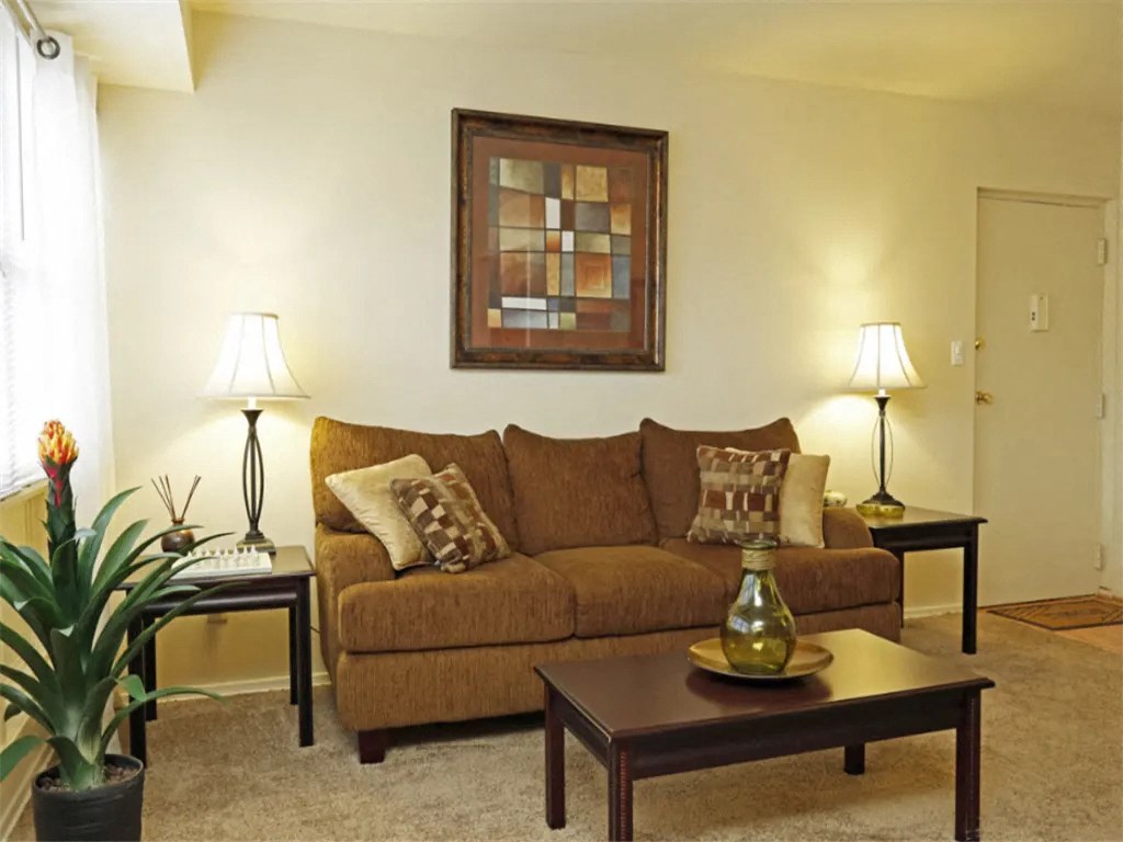a living room with a couch and a coffee table at Gates of West Bay, Norfolk, 23503