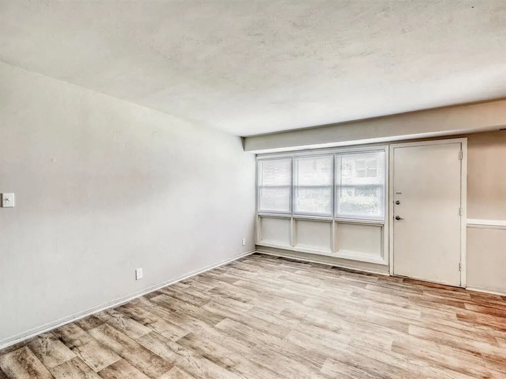 an empty living room with a window and a door at Gates of West Bay, Virginia