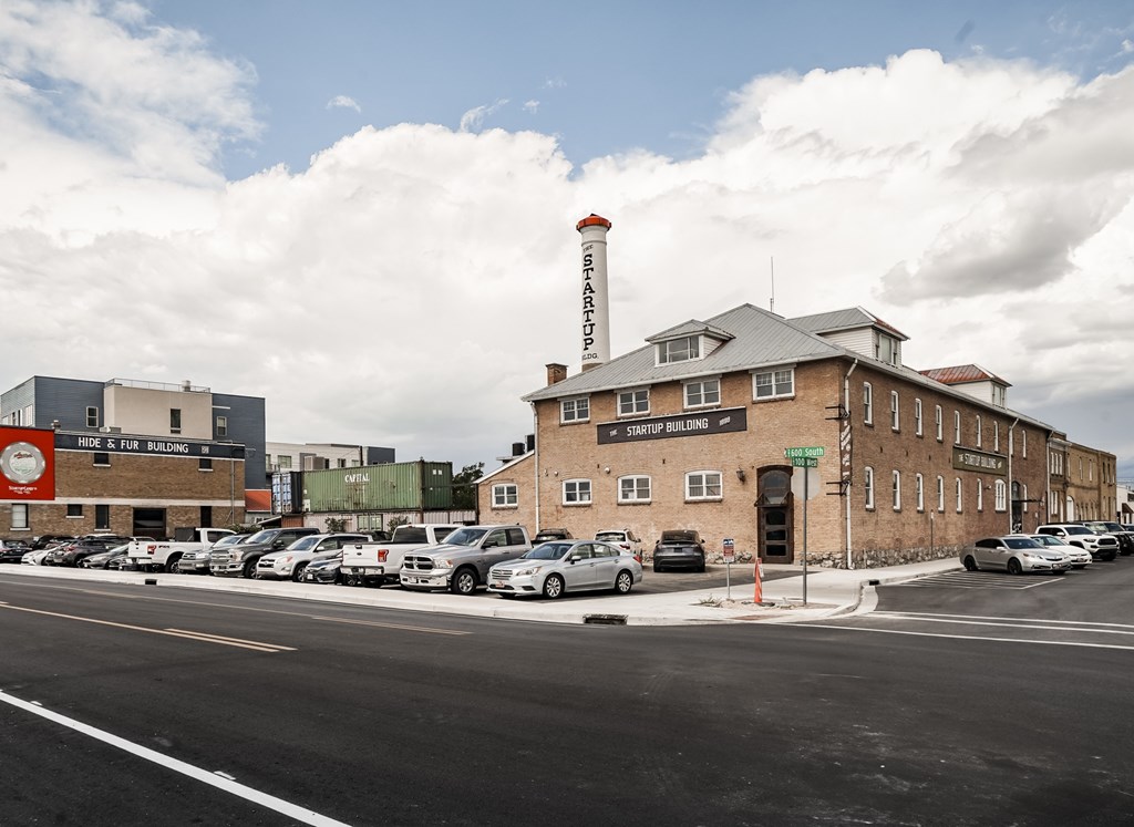 A parking lot with cars and a building with a sign that says "Sheriff's Office.".