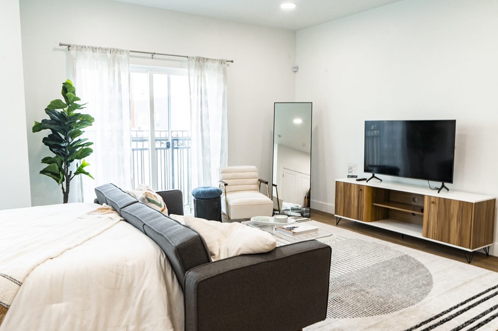 A modern bedroom with a large bed and a television.