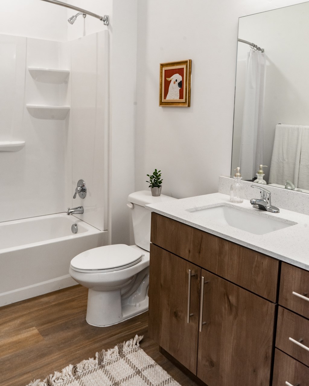 A white toilet sits in a bathroom next to a white sink.