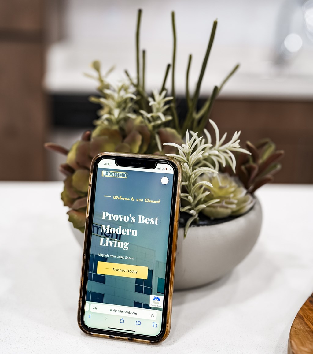 A phone displaying a website for Provo's Best Modern Living.