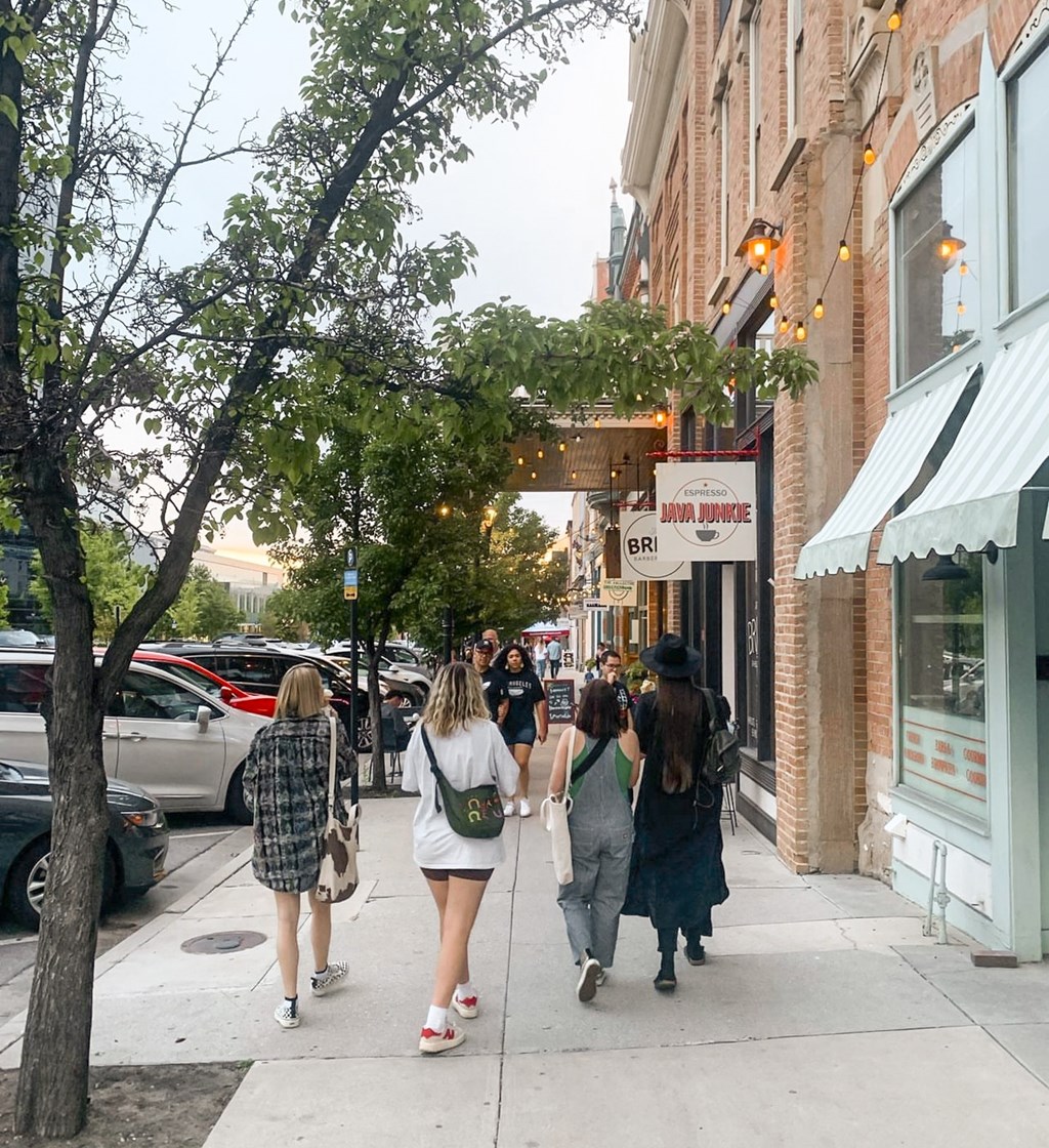 Four women walking down a sidewalk.