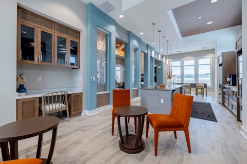 A modern kitchen with a dining table and chairs.