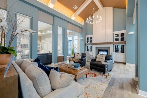 A living room with a grey couch and a wooden coffee table.