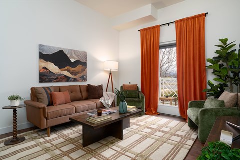 A living room with a brown couch, a coffee table, and a painting on the wall.