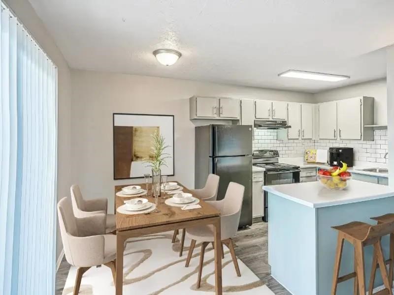 A kitchen with a dining table set for four.