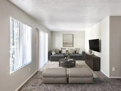 A living room with a grey couch and a coffee table.