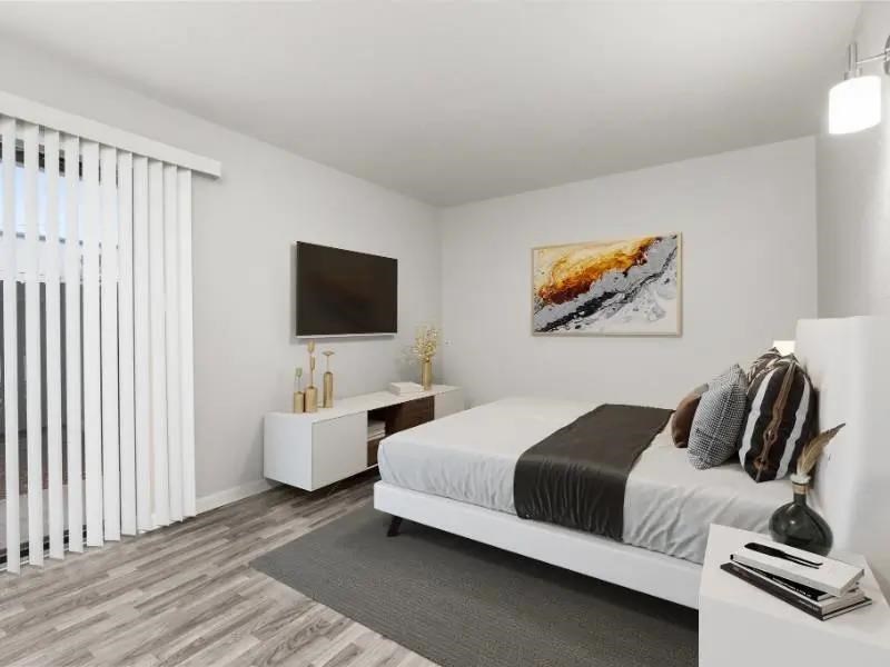 A bedroom with a bed, nightstand, and a painting on the wall.