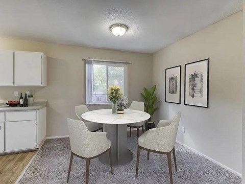 A dining room with a white table and chairs.