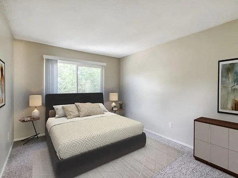 A bedroom with a large bed and a window.