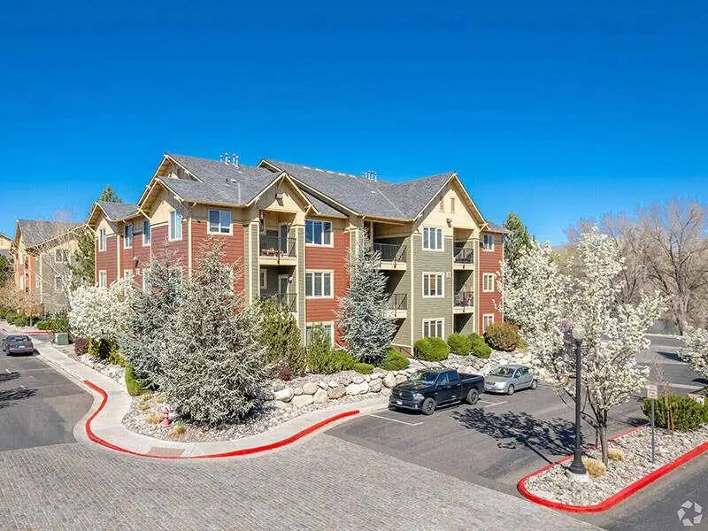 A large apartment complex with a red border around the parking lot.