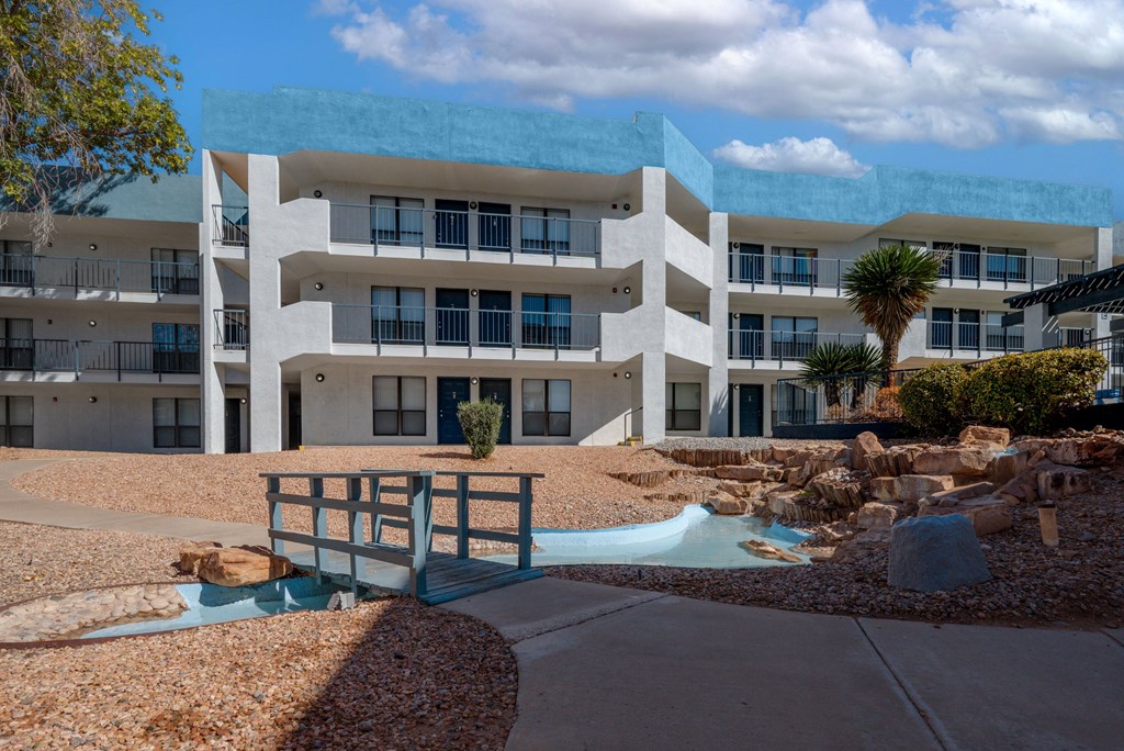 A modern building with a pool in front.