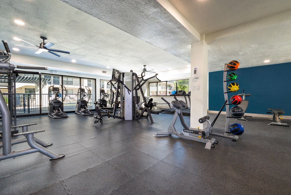 A gym with a variety of exercise equipment.