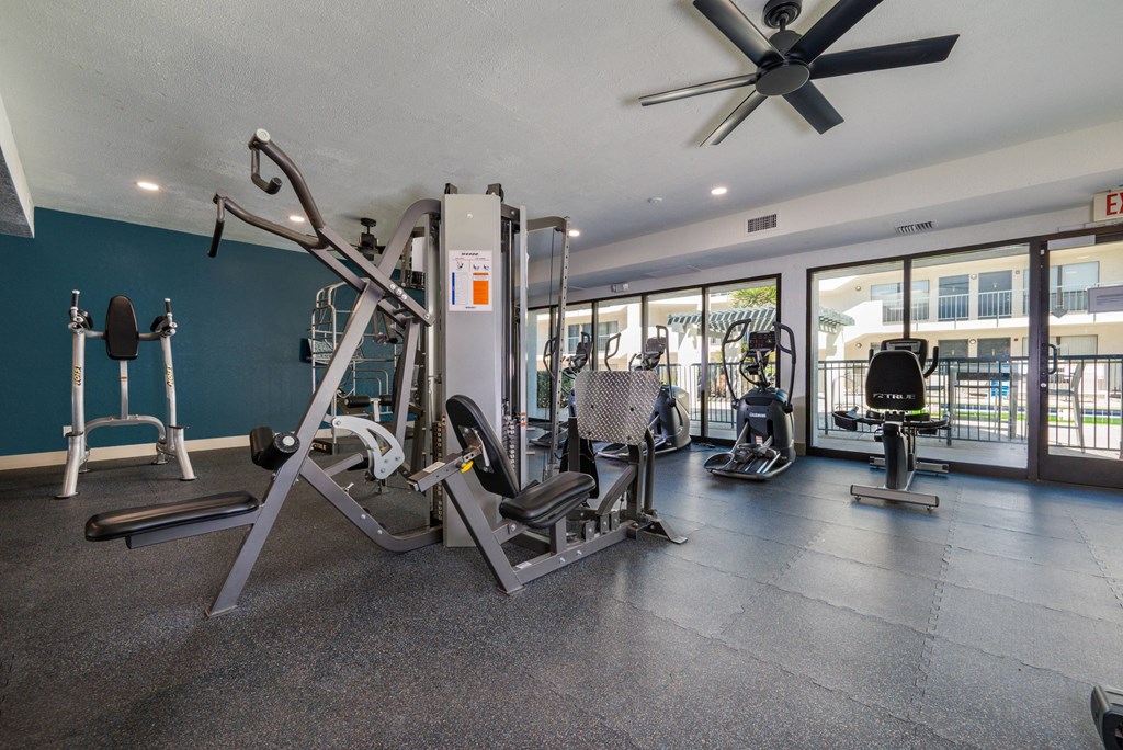A gym with a variety of equipment including a leg press machine.