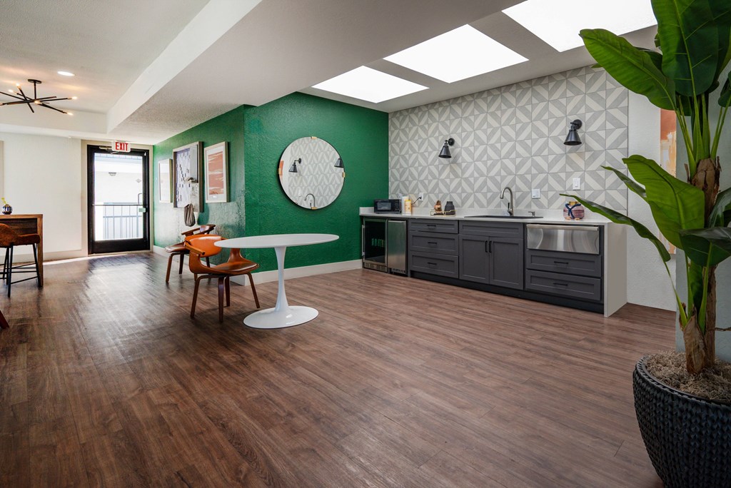 A room with a green wall and wooden floors.
