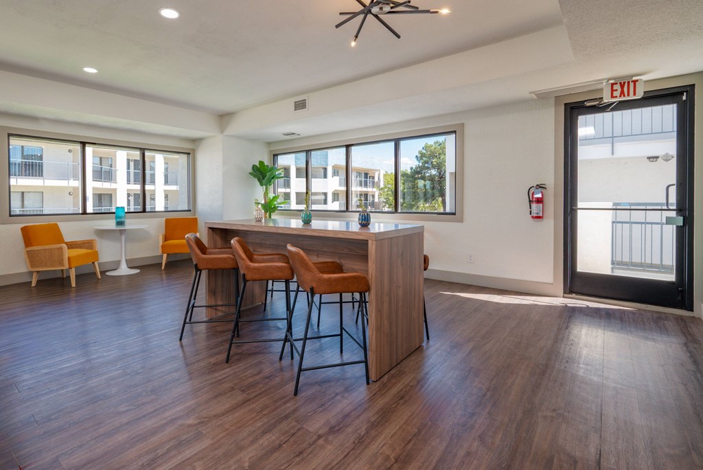 A conference room with a long table and chairs.