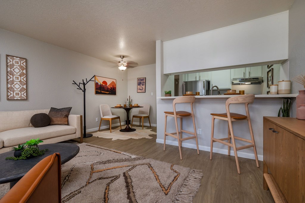 A living room with a couch, a table, and a rug.