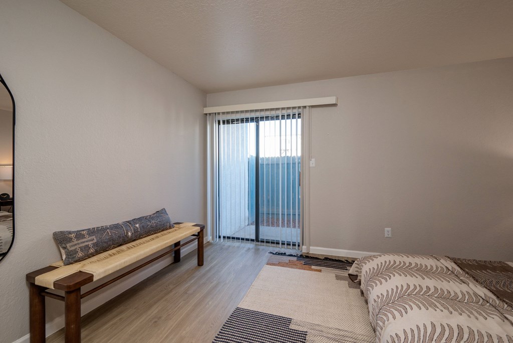 A room with a bench and a bed.