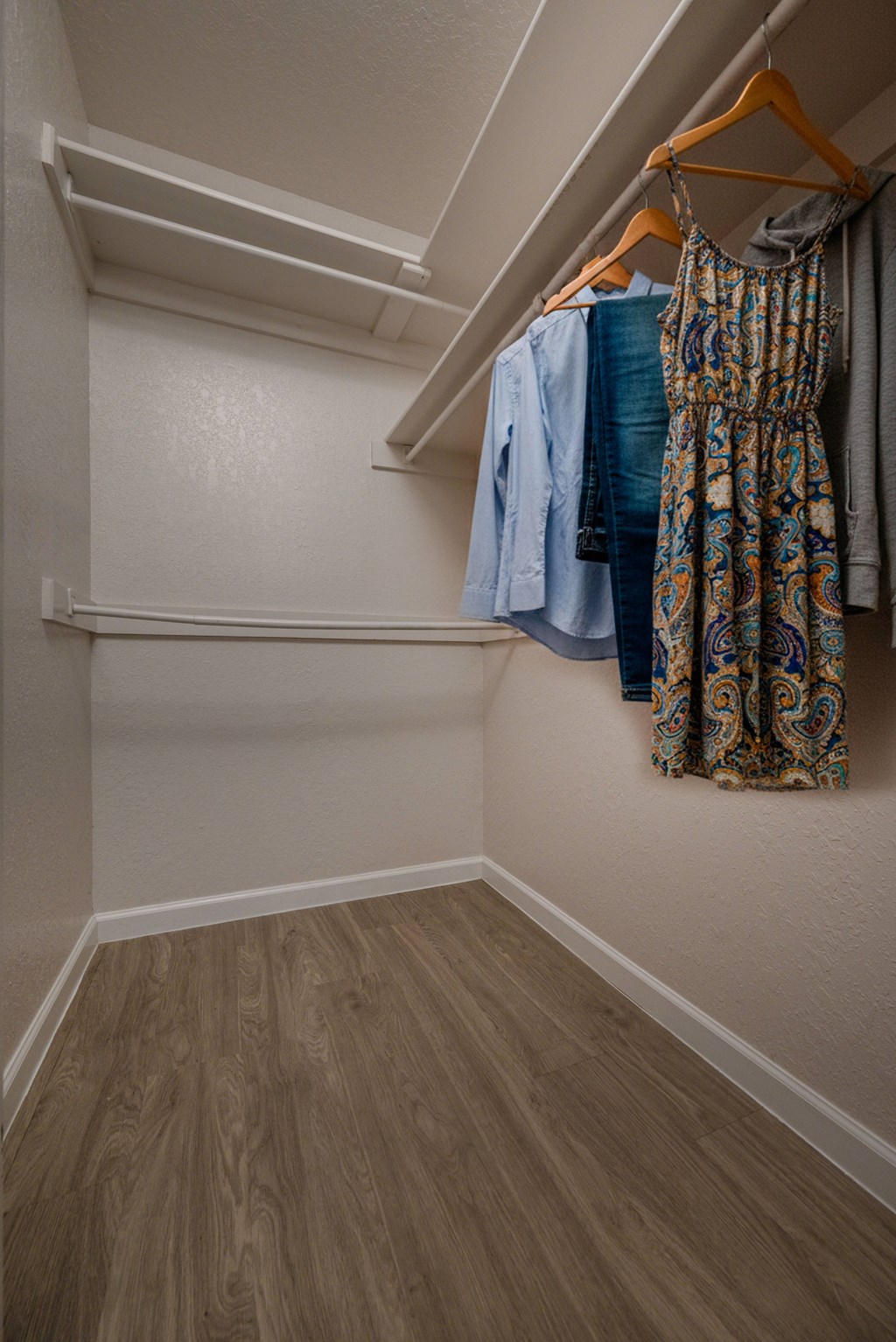 Clothes hanging on a rack in a room.