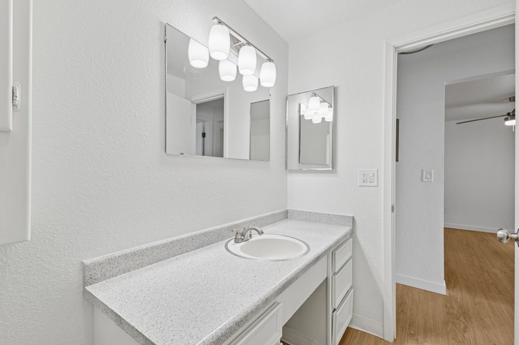 A bathroom with a sink and mirror.