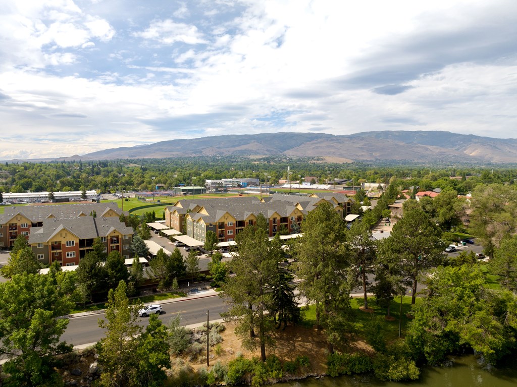 A view of a residential area with houses and trees.
