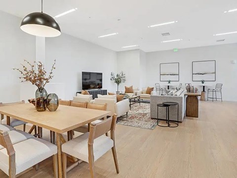 A modern dining room with a wooden table and chairs.