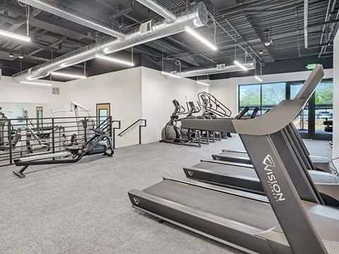 A treadmill with the brand name "Norwalk" on it is in a gym with other exercise equipment.