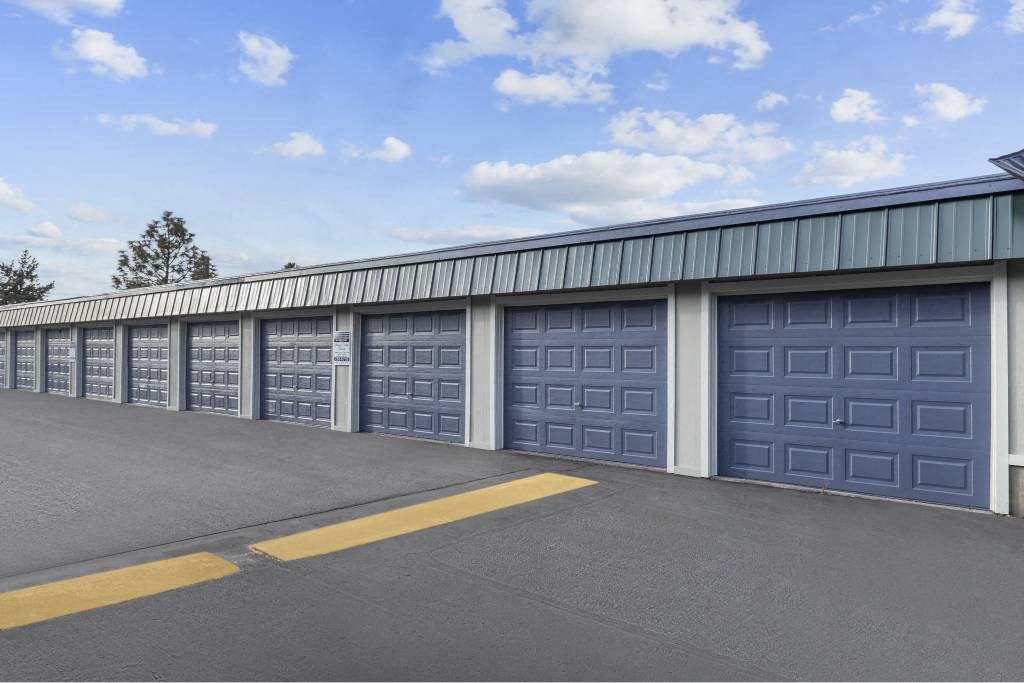 A long row of blue garage doors are closed.