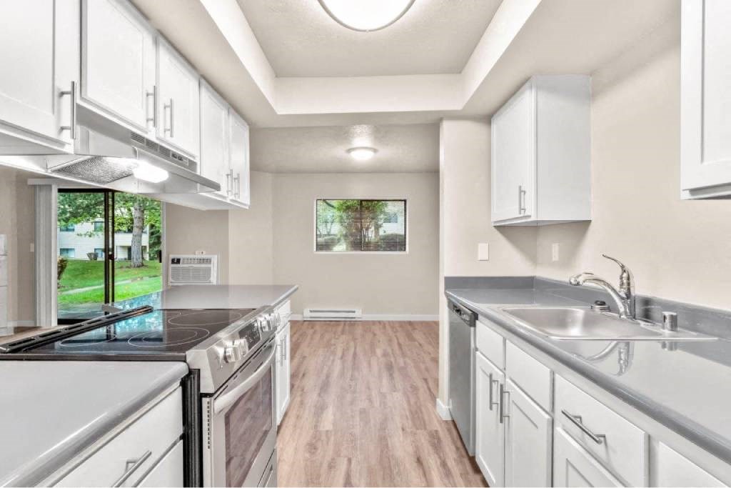 A kitchen with white appliances and cabinets.