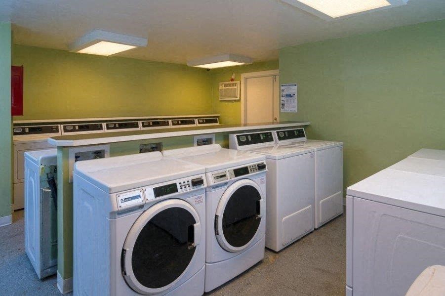 A row of washing machines in a laundry room.