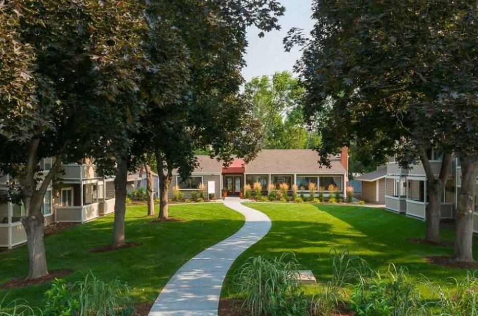 A pathway leads through a grassy area to a building.