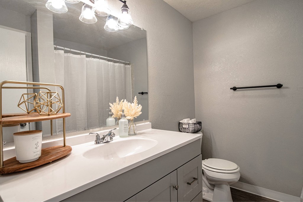 A bathroom with a white toilet and a white sink.