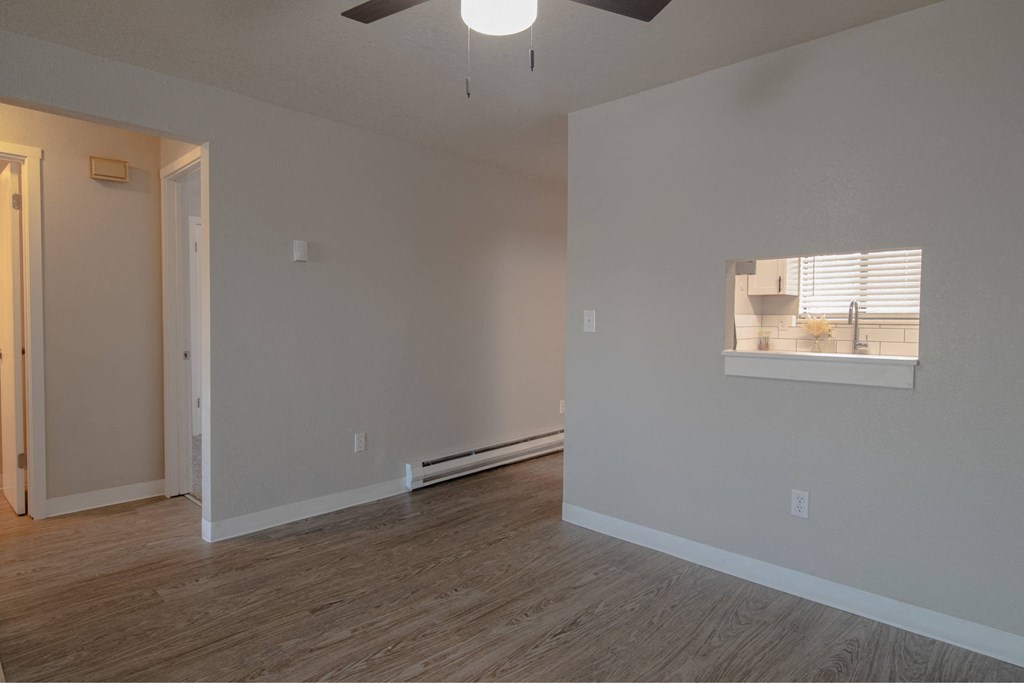 A room with a window and a ceiling fan.
