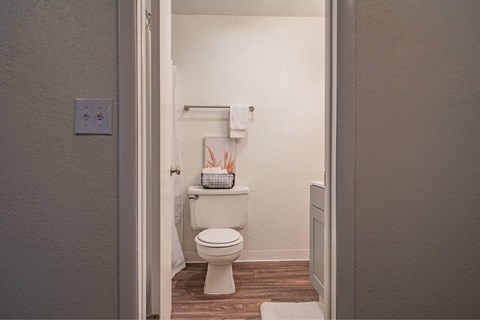 A white toilet in a small bathroom.