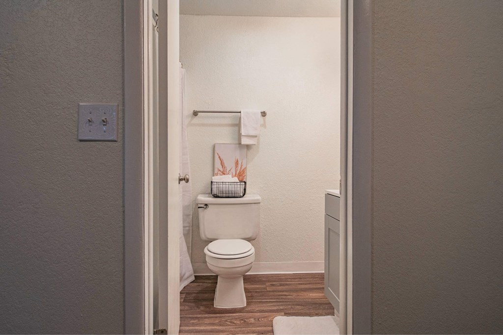 A white toilet in a small bathroom.