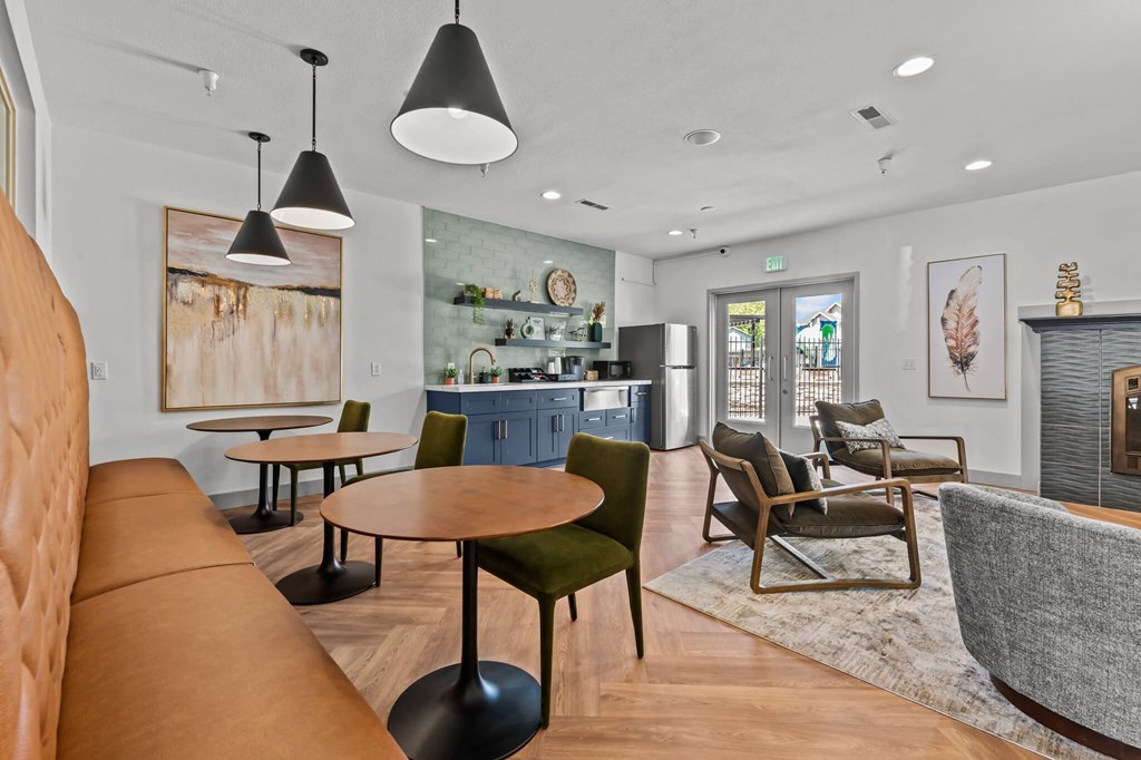 A modern living room with a brown leather sofa and a green chair.