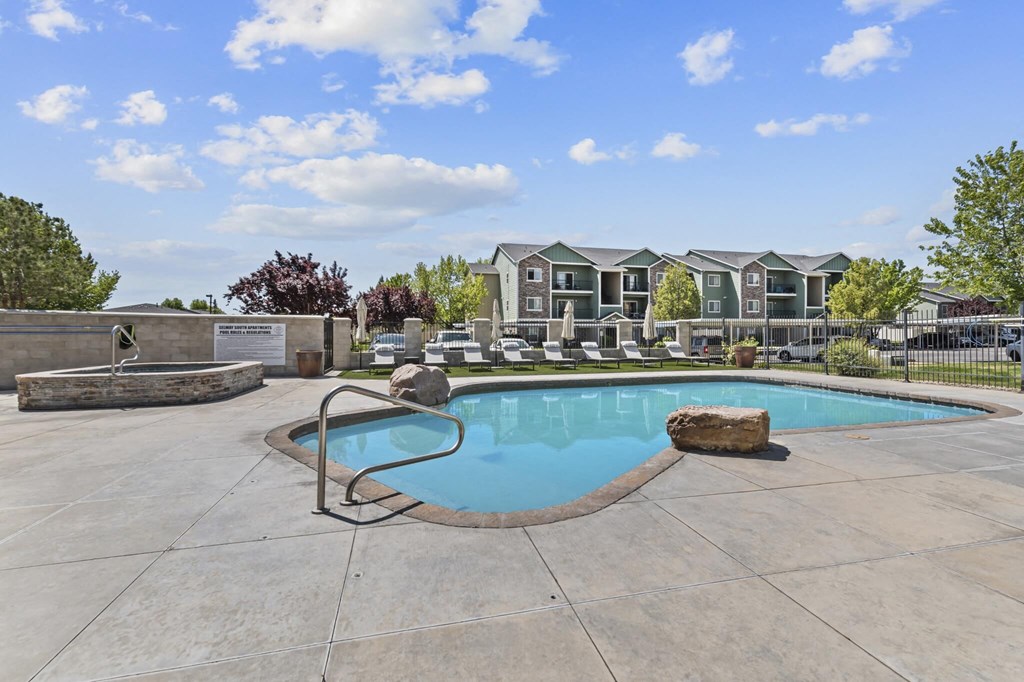 A swimming pool with a rock in the middle of it.