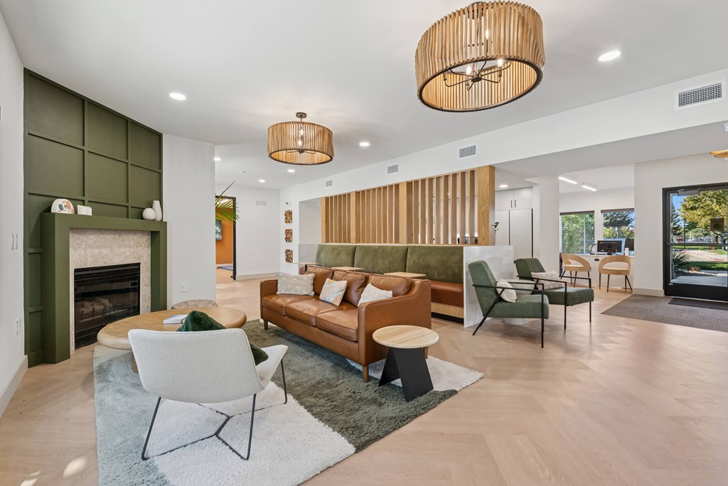 A modern living room with a fireplace and a green couch.